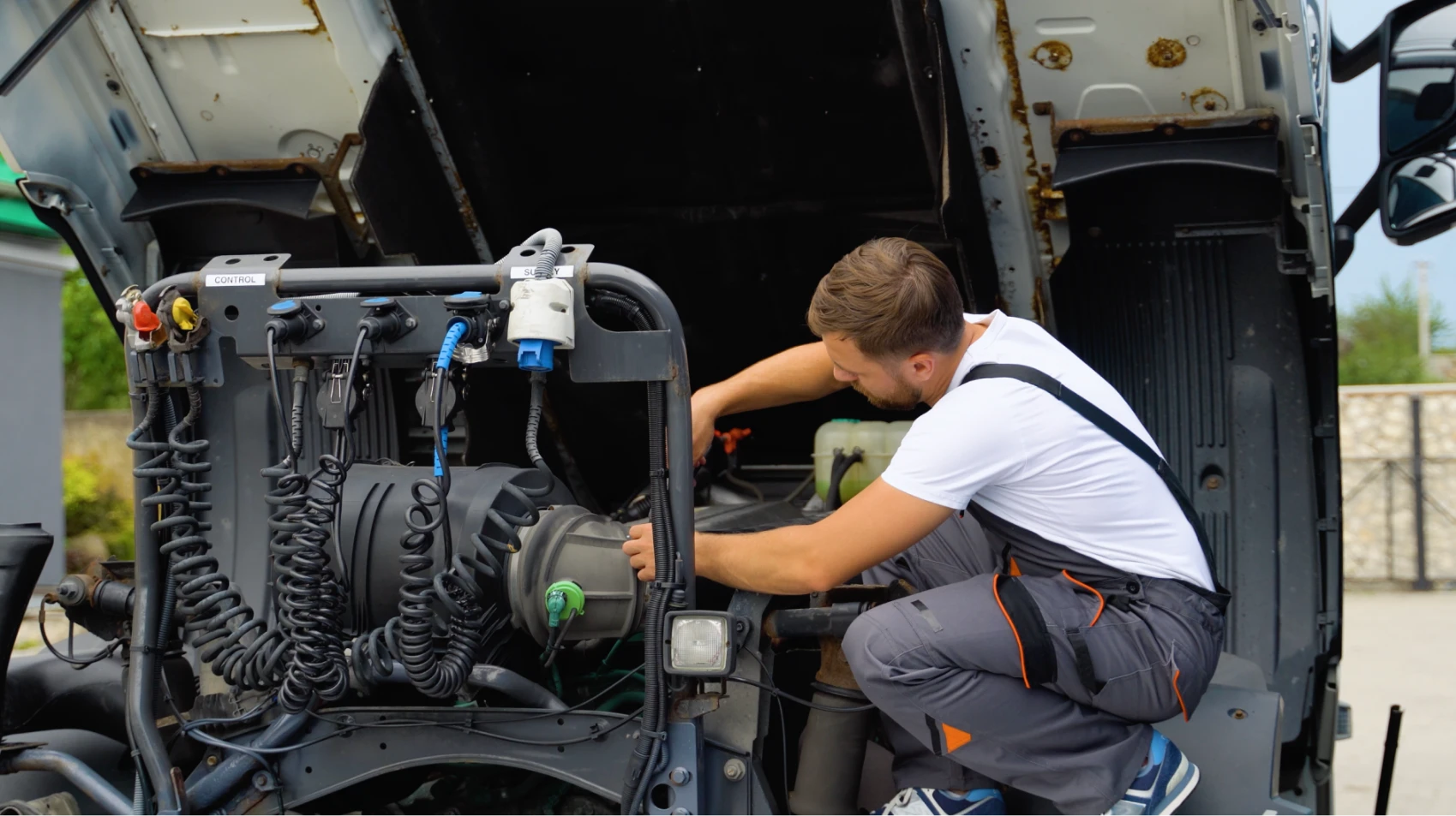 CPA technician repairing semi trailer lights and wiring during a mobile electrical service call